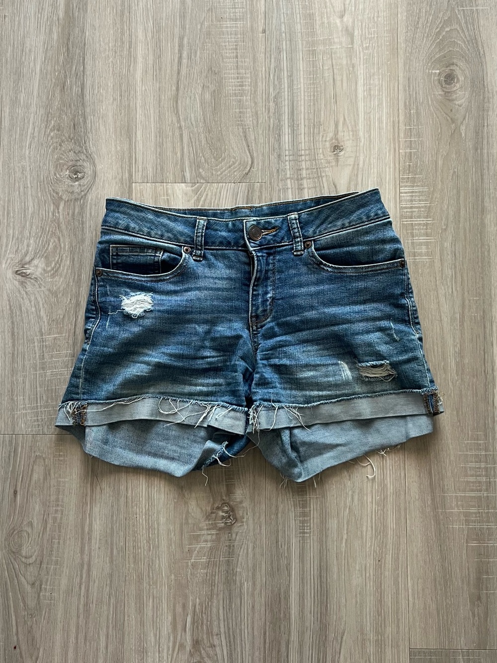 Blue denim jean shorts with distressed details